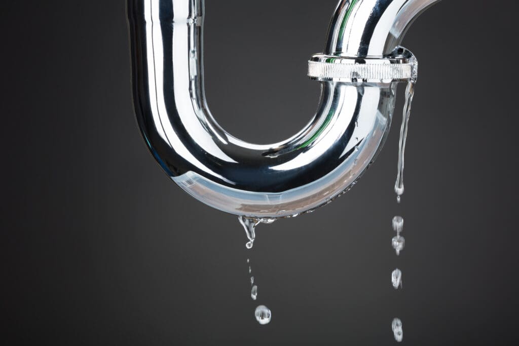 Leakage Of Water From Stainless Steel Pipe On Gray Background