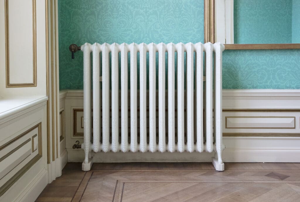 Old vintage heating radiator with valve, selective focus